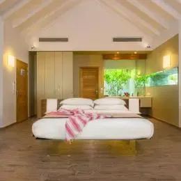 Спальня Beach Suite с парящей кроватью под высоким белым потолком