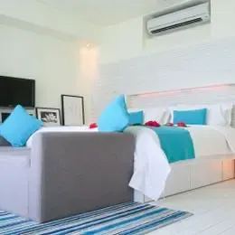 Beach Villa на Кандуме: спальня с большой кроватью и светильником-кубом у изголовья